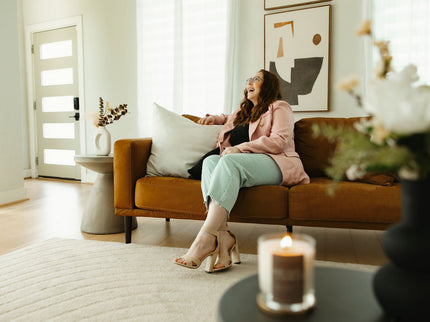 Upsensed founder Mikayla sitting beside a lit candle, reflecting the personal story behind the luxury candle brand.