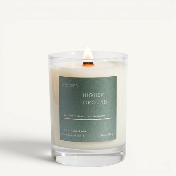Upsensed Higher Ground 11oz scented candle burning with wood wick - petrichor moss and fresh rainwater coconut apricot wax candle hand poured in Houston