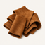Folded pieces of soft brown suede leather