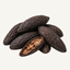 a pile of tonka beans representing the tonka bean fragrance note in the Sacre candle