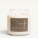Upsensed Café Doré 16 oz double-wick candle in a clear apothecary jar with a brown label, coffee bean, cinnamon, and cream scent notes, on a plain white background.