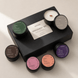 Upsensed Discovery Set Signature Collection black gift box surrounded by 6 mini candles — Higher Ground, Lignum, Intention, Alto, Nocturne, and Veil, hand poured in Houston with coconut-apricot wax
