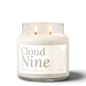 Cloud Nine 18 oz double-wick soy candle by Upsensed, both wicks lit, in a clear glass jar with a soft cream label in warm gray type listing freesia, lily, cashmere, and woods notes.