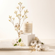 Upsensed Cloudwash candle on white pedestal surrounded by cotton bolls, jasmine flowers, and sandalwood chips on a marble surface