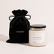 Upsensed Cloudwash candle with a black lid beside its black velvet UPSENSED drawstring packaging bag, on a cream background.