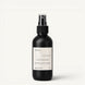 A matte black room & linen spray bottle with a white label, featuring the brand name 'Upsensed' and product name 'Cloudwash', set against a clean off-white background.