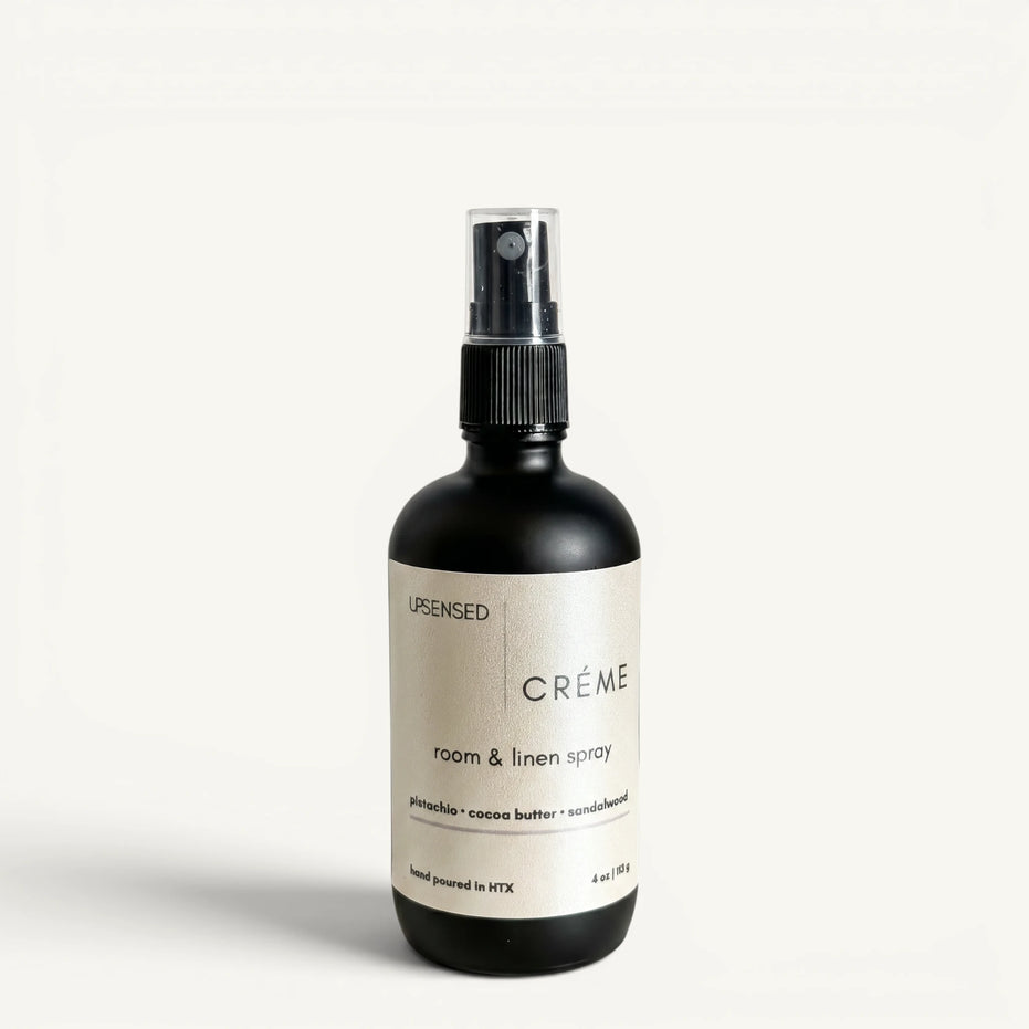 Upsensed Creme 4oz Room and Linen Spray in matte black bottle with cream label - pistachio cocoa butter and sandalwood linen spray hand poured in Houston