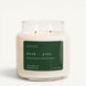 An Upsensed 'dusk + pine' scented candle in a clear glass jar with two lit wicks, featuring a dark green label on a clean white background.