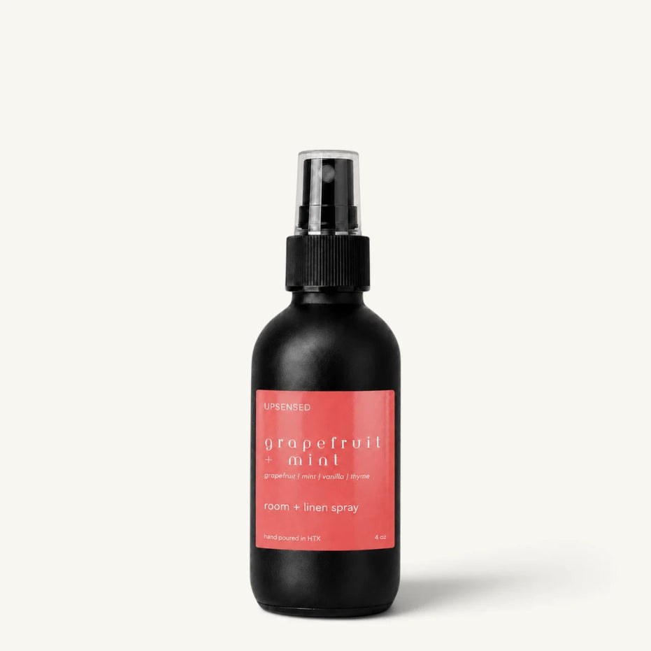 Upsensed Grapefruit + Mint room and linen spray in a matte black 4 oz bottle with coral red label