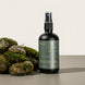 Upsensed Higher Ground Room and Linen Spray surrounded by moss-covered wet stones - petrichor and rainwater home fragrance hand poured in Houston