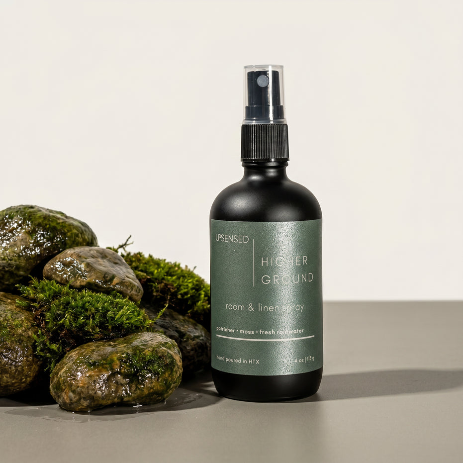 Upsensed Higher Ground Room and Linen Spray surrounded by moss-covered wet stones - petrichor and rainwater home fragrance hand poured in Houston