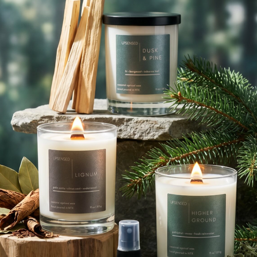 Instagram post from @upsensed — Upsensed Dusk & Pine, Lignum, and Higher Ground candles styled with pine branches, palo santo, and stone