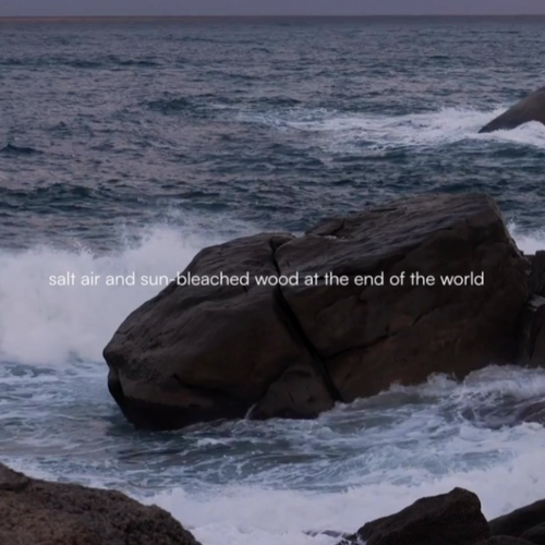 Instagram post from @upsensed — waves crashing over coastal rocks with the text "salt air and sun-bleached wood at the end of the world"
