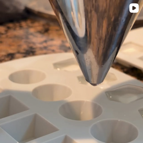 Instagram post from @upsensed — liquid wax being poured into small molds, showing the hand-poured candle-making process