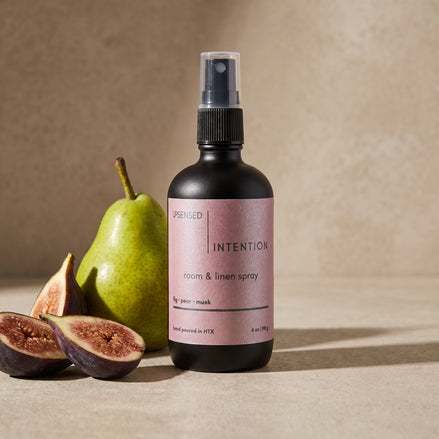 Upsensed Intention Room and Linen Spray beside fresh sliced figs and ripe pear - fruity floral home fragrance hand poured in Houston