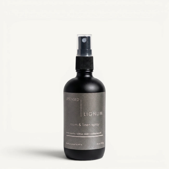 Upsensed Lignum 4oz Room and Linen Spray in matte black bottle with charcoal label - palo santo citrus zest and cedarwood linen spray