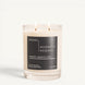 Magnetic Reserve candle with black label in a clear glass jar, two wicks lit.
