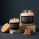 Magnetic Reserve 8 oz and 18 oz soy candles by Upsensed, lit, on travertine stone risers against a dark navy backdrop, with a halved grapefruit, a cedar block with shavings, and black peppercorns.