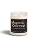 Magnetic Reserve 8 oz soy candle by Upsensed, lit, in a clear glass jar with a black label listing Japanese grapefruit, peppercorn, and cedar notes.