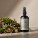 Upsensed Moss Room and Linen Spray beside fresh oakmoss and botanical botanicals - earthy amber home fragrance hand poured in Houston
