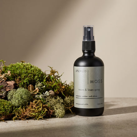 Upsensed Moss Room and Linen Spray beside fresh oakmoss and botanical botanicals - earthy amber home fragrance hand poured in Houston