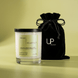 Upsensed Pearfect candle beside reusable black velvet drawstring gift bag on chartreuse background