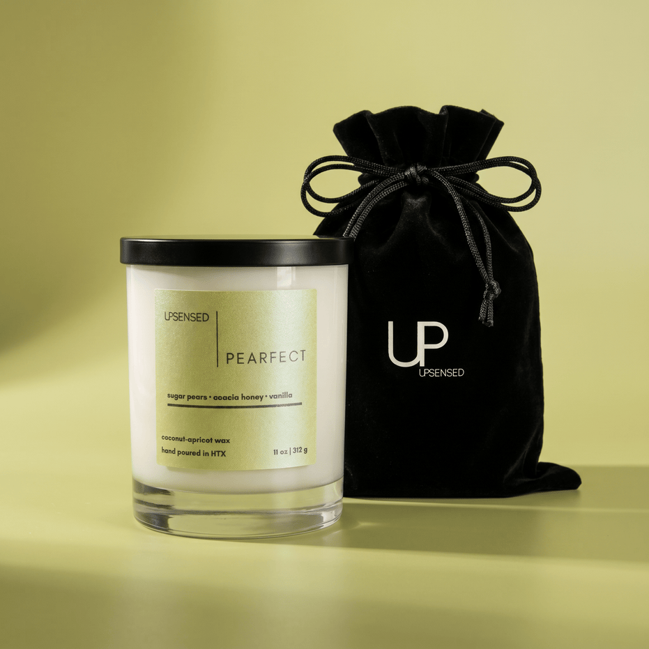 Upsensed Pearfect candle beside reusable black velvet drawstring gift bag on chartreuse background
