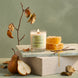 Upsensed Pearfect gourmand candle styled with fresh pears, honeycomb, and vanilla beans on a marble surface with sage green background