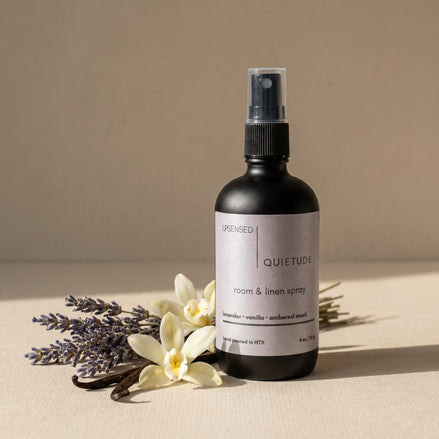 Upsensed Quietude room and linen spray with lavender, vanilla, and ambered musk on a warm neutral surface