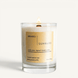 Upsensed Sunward candle lit on white background, showing gold label with sunlit citrus, fig leaf, and hinoki woods notes