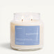 Upsensed Undertow 16 oz double-wick candle in a clear apothecary jar with a dusty blue label, marine minerals, coastal driftwood, and cedar scent notes, on a plain white background.