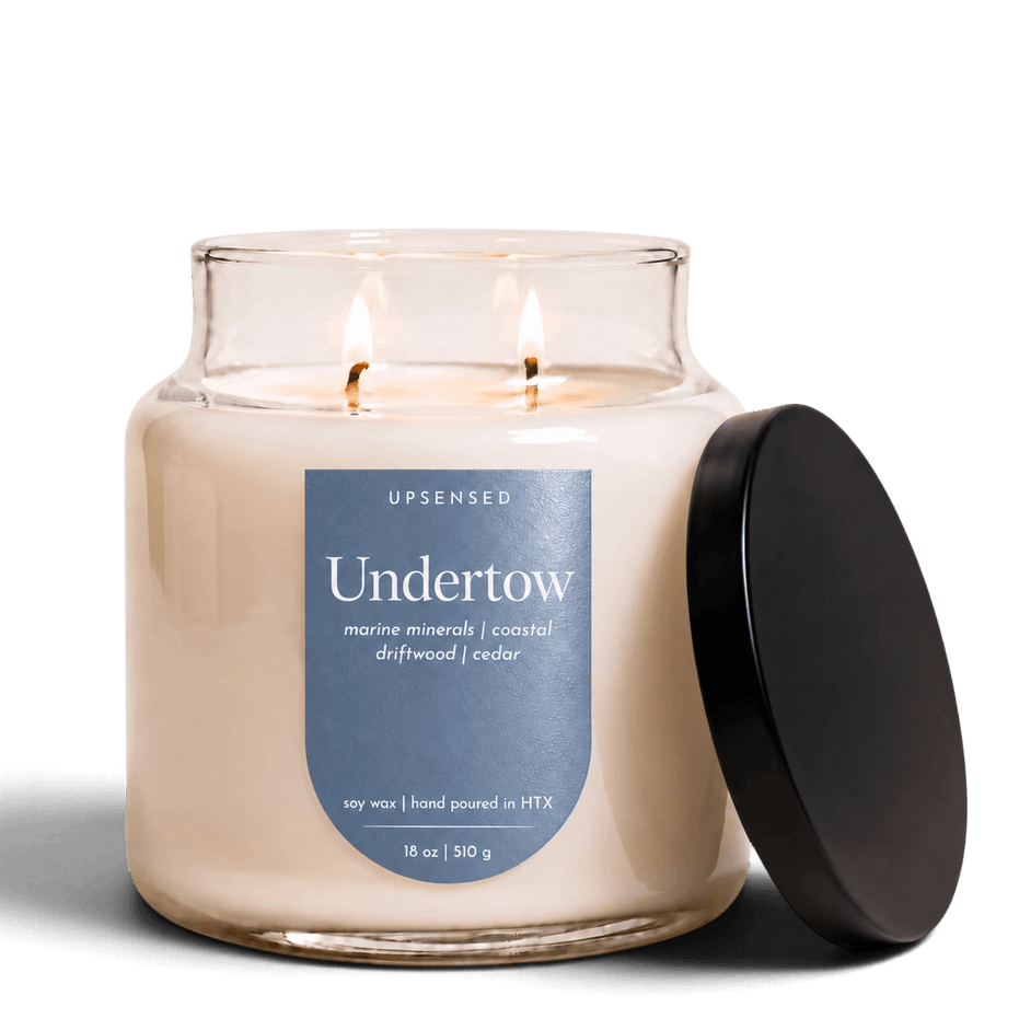 Upsensed Undertow 18 oz double-wick candle in an apothecary jar with matte black lid