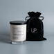 Upsensed Undertow candle beside reusable black velvet drawstring gift bag on steel blue background