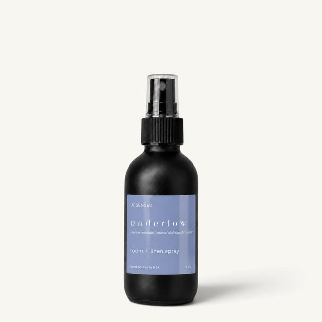 Upsensed Undertow room and linen spray in a matte black 4 oz bottle with blue label