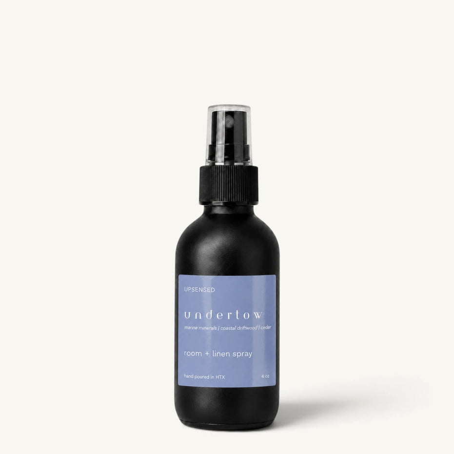 Upsensed Undertow room and linen spray in a matte black 4 oz bottle with blue label