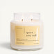 Upsensed Yuzu + Sea Salt 16 oz double-wick candle in a clear apothecary jar with a pale yellow label, bergamot, sea salt, and yuzu scent notes, on a plain white background.