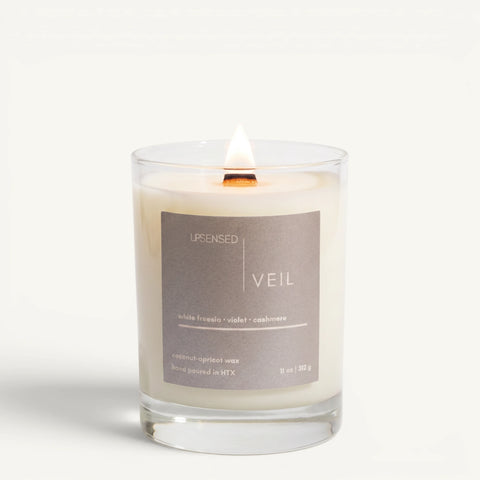 Upsensed Veil 11oz scented candle burning with wood wick - white freesia violet and cashmere coconut apricot wax candle hand poured in Houston
